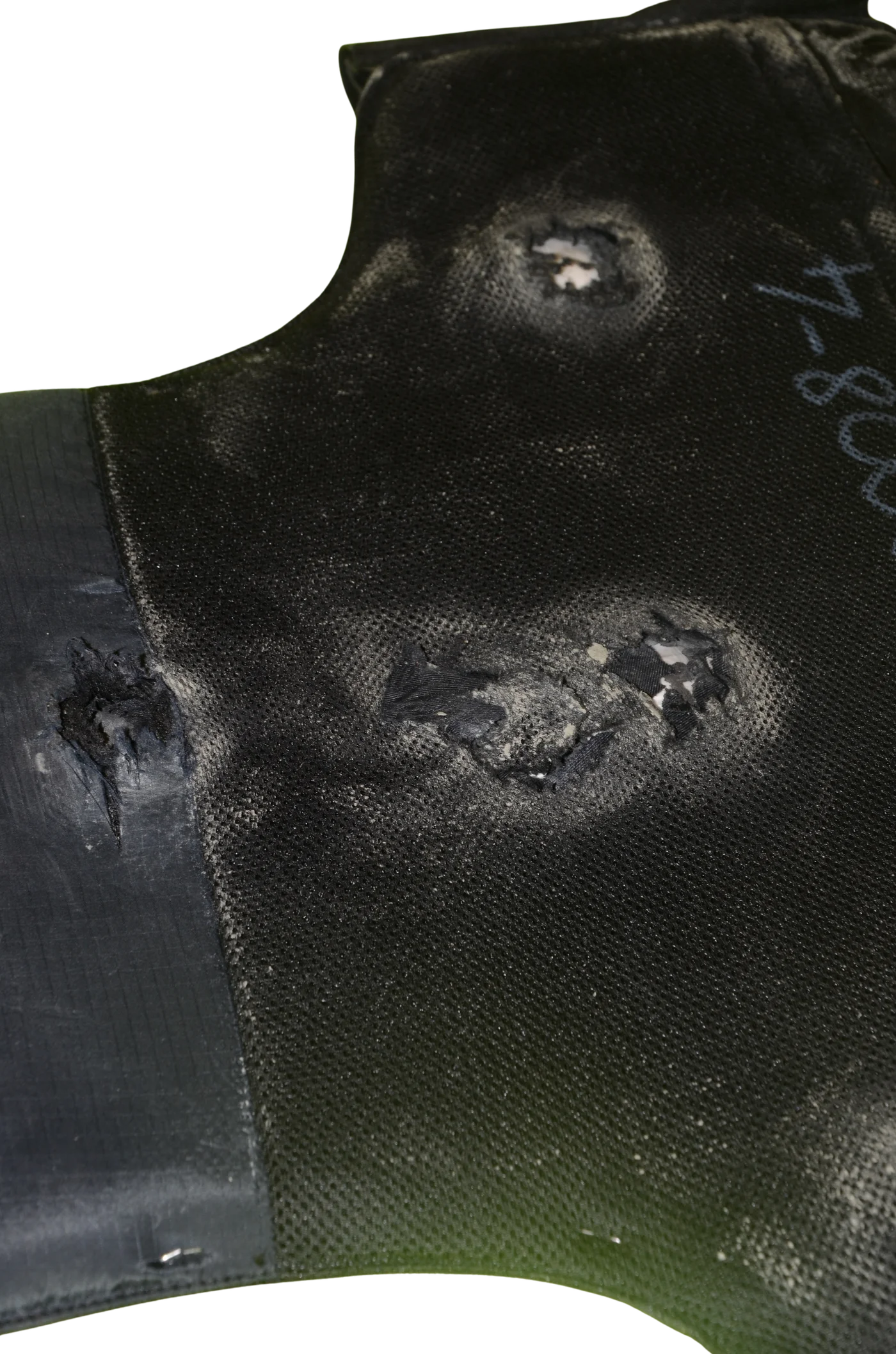 Inner face of the panel showing backface deformation behind two impact points, liner intact.